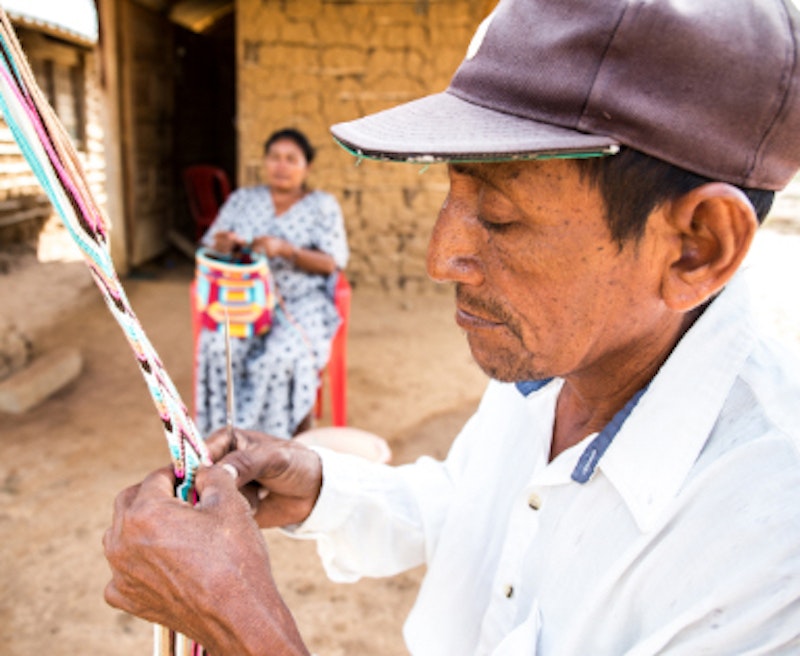 man is weaving a beautiful ornament