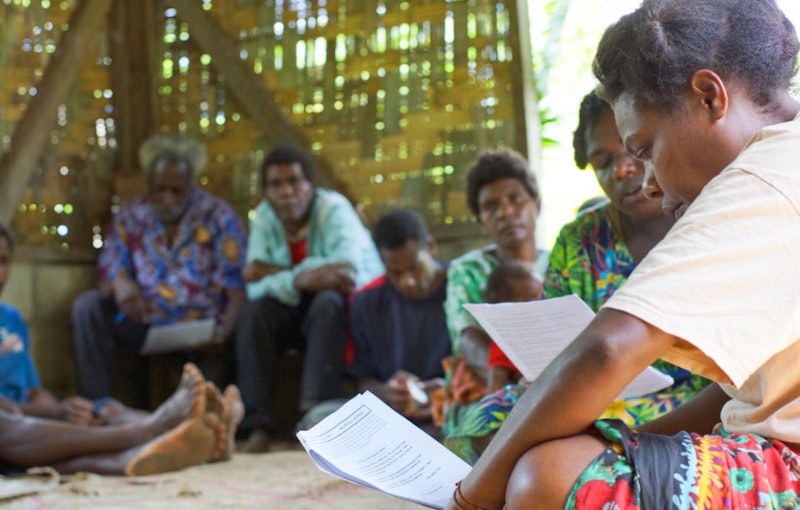 people in the rural area are studying the materials together