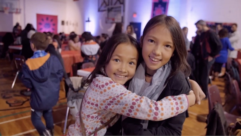 a girl hugs her sister