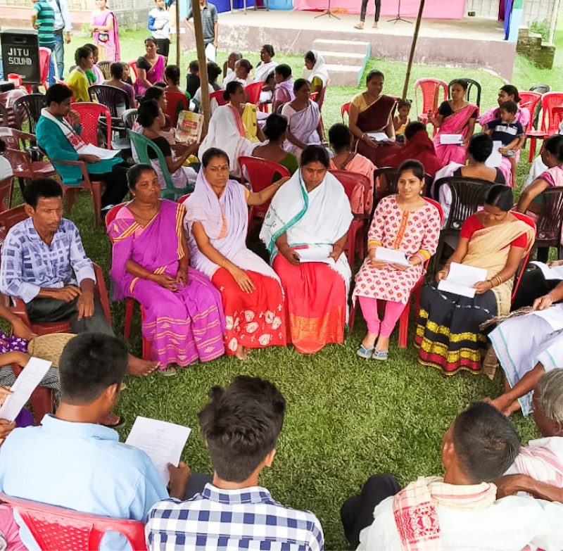 indian gathering, people sit in a circle